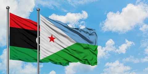 Libya and Djibouti flag waving in the wind against white cloudy blue sky together. Diplomacy concept, international relations.
