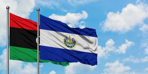 Libya and El Salvador flag waving in the wind against white cloudy blue sky together. Diplomacy concept, international relations.