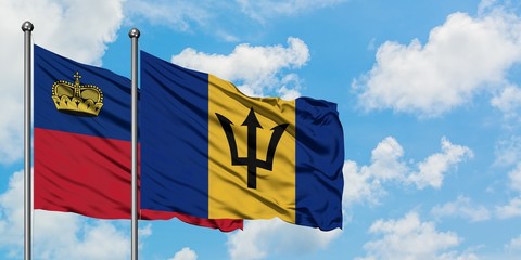 Liechtenstein and Barbados flag waving in the wind against white cloudy blue sky together. Diplomacy concept, international relations.
