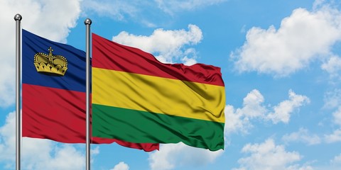 Liechtenstein and Bolivia flag waving in the wind against white cloudy blue sky together. Diplomacy concept, international relations.