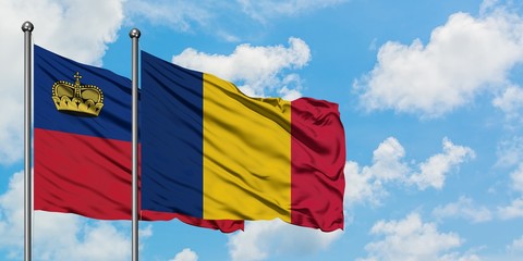 Liechtenstein and Chad flag waving in the wind against white cloudy blue sky together. Diplomacy concept, international relations.