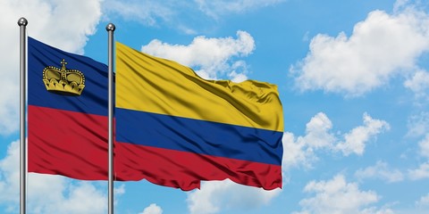 Liechtenstein and Colombia flag waving in the wind against white cloudy blue sky together. Diplomacy concept, international relations.