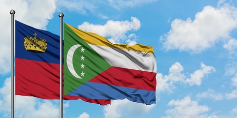 Liechtenstein and Comoros flag waving in the wind against white cloudy blue sky together. Diplomacy concept, international relations.