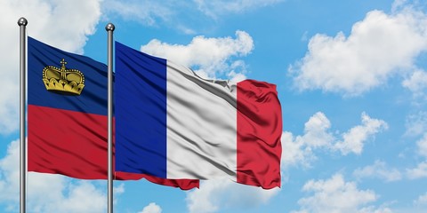 Liechtenstein and France flag waving in the wind against white cloudy blue sky together. Diplomacy concept, international relations.