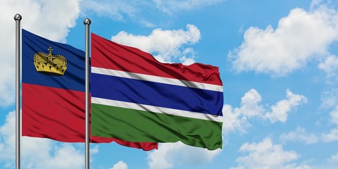 Liechtenstein and Gambia flag waving in the wind against white cloudy blue sky together. Diplomacy concept, international relations.