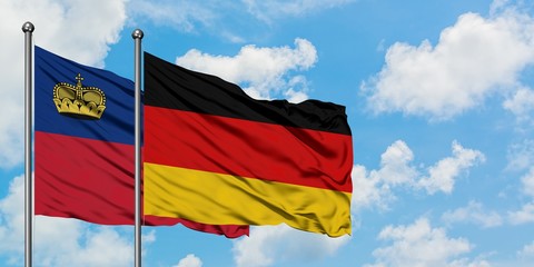 Liechtenstein and Germany flag waving in the wind against white cloudy blue sky together. Diplomacy concept, international relations.