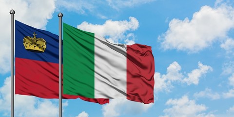 Liechtenstein and Italy flag waving in the wind against white cloudy blue sky together. Diplomacy concept, international relations.