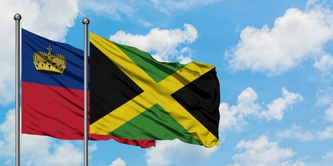 Liechtenstein and Jamaica flag waving in the wind against white cloudy blue sky together. Diplomacy concept, international relations.