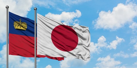 Liechtenstein and Japan flag waving in the wind against white cloudy blue sky together. Diplomacy concept, international relations.