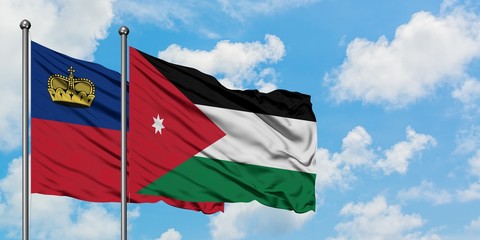 Liechtenstein and Jordan flag waving in the wind against white cloudy blue sky together. Diplomacy concept, international relations.