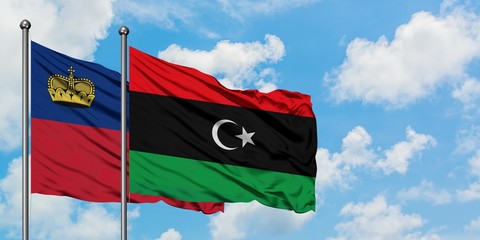Liechtenstein and Libya flag waving in the wind against white cloudy blue sky together. Diplomacy concept, international relations.