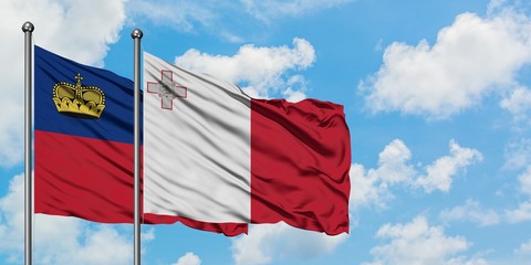 Liechtenstein and Malta flag waving in the wind against white cloudy blue sky together. Diplomacy concept, international relations.