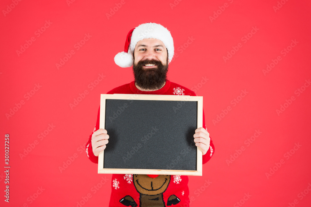 Poster Winter announcement. Winter event. Winter holidays. Man with beard hold blank blackboard copy space. Guy santa claus red background. Santa Claus hat with advertisement. Chalkboard for information