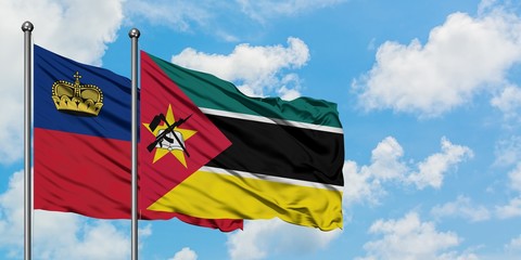 Liechtenstein and Mozambique flag waving in the wind against white cloudy blue sky together. Diplomacy concept, international relations.