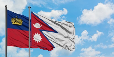 Liechtenstein and Nepal flag waving in the wind against white cloudy blue sky together. Diplomacy concept, international relations.