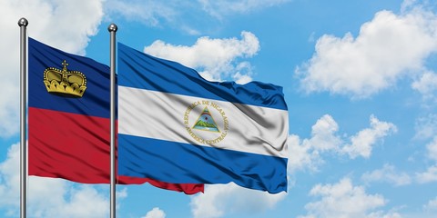 Liechtenstein and Nicaragua flag waving in the wind against white cloudy blue sky together. Diplomacy concept, international relations.