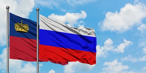 Liechtenstein and Russia flag waving in the wind against white cloudy blue sky together. Diplomacy concept, international relations.