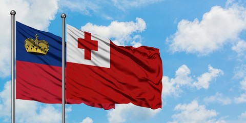 Liechtenstein and Tonga flag waving in the wind against white cloudy blue sky together. Diplomacy concept, international relations.