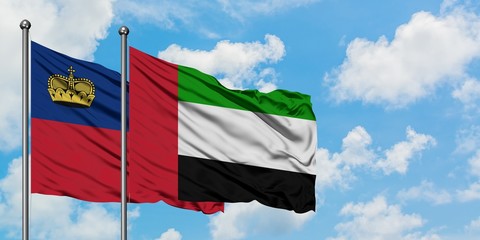 Liechtenstein and United Arab Emirates flag waving in the wind against white cloudy blue sky together. Diplomacy concept, international relations.