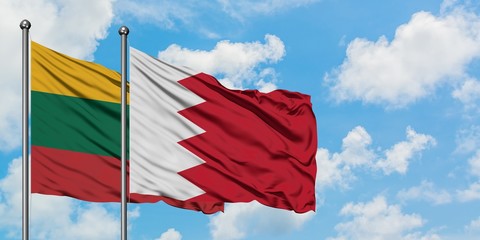 Lithuania and Bahrain flag waving in the wind against white cloudy blue sky together. Diplomacy concept, international relations.