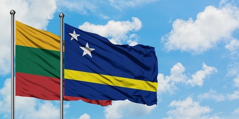 Lithuania and Curacao flag waving in the wind against white cloudy blue sky together. Diplomacy concept, international relations.