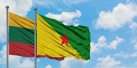Lithuania and French Guiana flag waving in the wind against white cloudy blue sky together. Diplomacy concept, international relations.