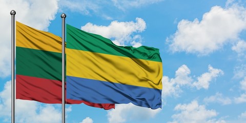 Lithuania and Gabon flag waving in the wind against white cloudy blue sky together. Diplomacy...