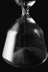 Crystal hourglass on dark background, closeup