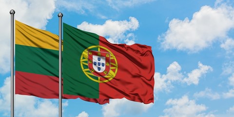 Lithuania and Portugal flag waving in the wind against white cloudy blue sky together. Diplomacy concept, international relations.