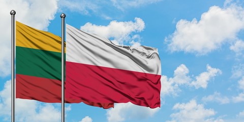 Lithuania and Poland flag waving in the wind against white cloudy blue sky together. Diplomacy concept, international relations.