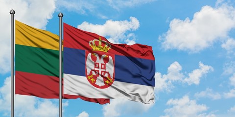 Lithuania and Serbia flag waving in the wind against white cloudy blue sky together. Diplomacy concept, international relations.