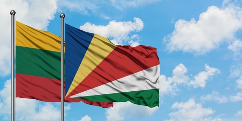 Lithuania and Seychelles flag waving in the wind against white cloudy blue sky together. Diplomacy concept, international relations.