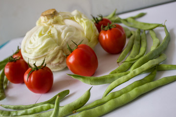 Close up of various colorful raw vegetables isolated on white background