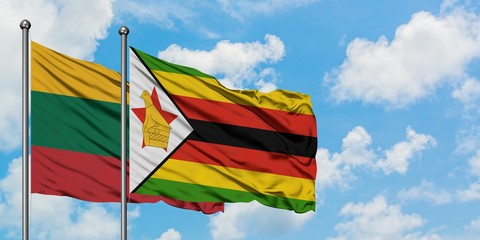Lithuania and Zimbabwe flag waving in the wind against white cloudy blue sky together. Diplomacy concept, international relations.