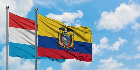 Luxembourg and Ecuador flag waving in the wind against white cloudy blue sky together. Diplomacy concept, international relations.