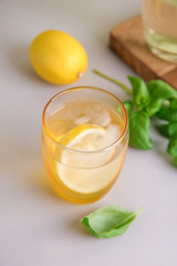 Glass of fresh lemonade on table