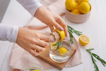 Woman making fresh lemonade in kitchen