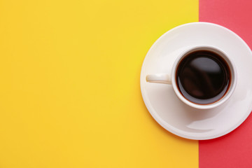 Cup of hot coffee on color background