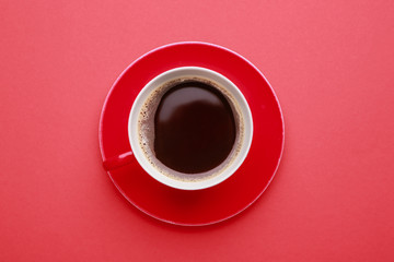 Cup of hot coffee on color background