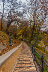 Fototapeta na wymiar KIEV, UKRAINE - Oktober 27 2019: Autumn in Kiev park. Saint Vladimir Monument view through yellow tree foliage in Vladimir park and view of Dnieper River in urban park Volodymyrska Hill