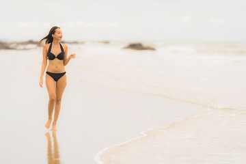 Portrait beautiful young asian woman wear bikini on the beach sea ocean