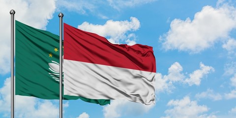 Macao and Indonesia flag waving in the wind against white cloudy blue sky together. Diplomacy concept, international relations.