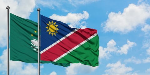 Macao and Namibia flag waving in the wind against white cloudy blue sky together. Diplomacy concept, international relations.