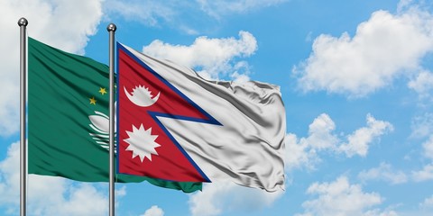 Macao and Nepal flag waving in the wind against white cloudy blue sky together. Diplomacy concept, international relations.
