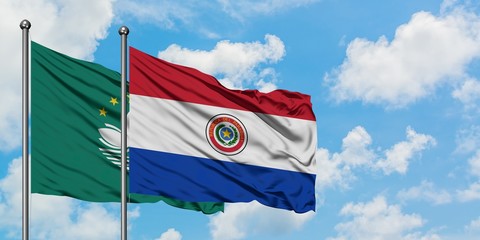 Macao and Paraguay flag waving in the wind against white cloudy blue sky together. Diplomacy concept, international relations.