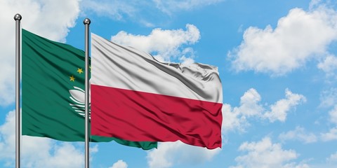 Macao and Poland flag waving in the wind against white cloudy blue sky together. Diplomacy concept, international relations.