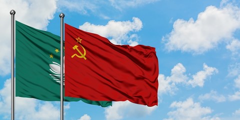 Macao and Soviet Union flag waving in the wind against white cloudy blue sky together. Diplomacy...