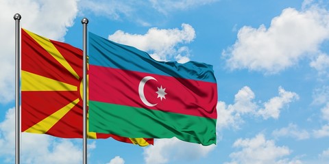 Macedonia and Azerbaijan flag waving in the wind against white cloudy blue sky together. Diplomacy concept, international relations.