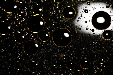Golden oil bubbles macro on water black background with bokeh fifty megapixels prints