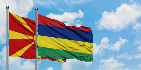 Macedonia and Mauritius flag waving in the wind against white cloudy blue sky together. Diplomacy concept, international relations.